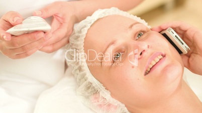Woman talking on the phone at beauty spa