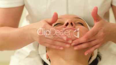 Woman relaxing during facial therapy at beauty spa