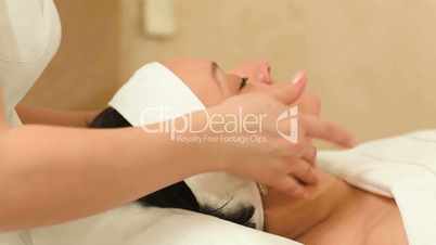 Professional facial massage at beauty spa