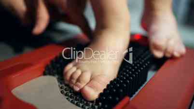 Child foot on orthopedic device helping to create a perfect-fitting shoes