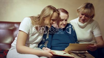 Three women looking through the family archive