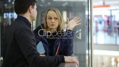 Man and woman discussing something in trade center