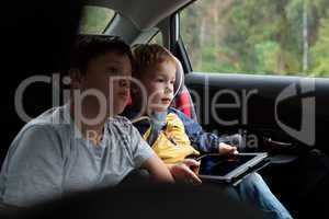 Two boys in the car with tablet PC