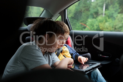 Boys in the car using a touchpad