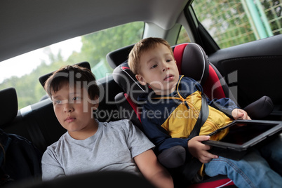 Children sitting in the car and looking at the road