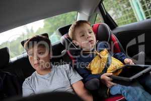 Children sitting in the car and looking at the road