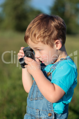 Little child taking pictures outdoor