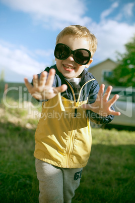 Happy boy in big sunglasses outdoor