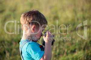 Little boy with camera outdoor