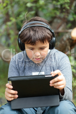 Teen boy in headphones with pad