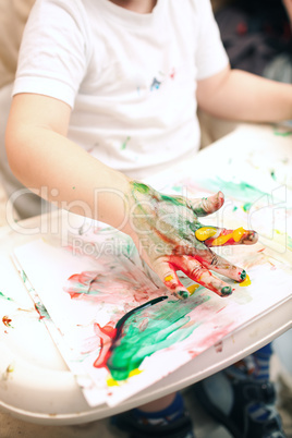 Boy painting with finger-paints