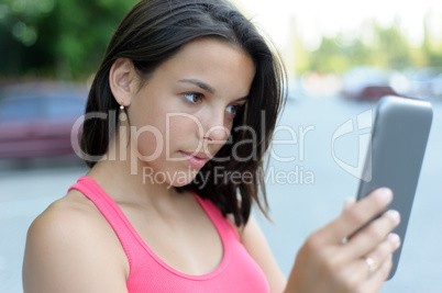 Girl using tablet PC outdoor