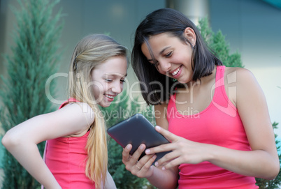 Two teen girls with tablet PC