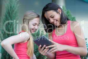 Two teen girls with tablet PC