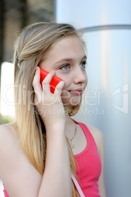 Young girl talking on the phone outdoor
