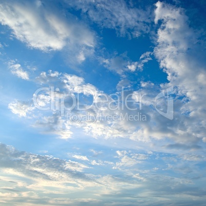 The white cumulus clouds against the blue sky