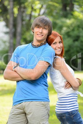 Teenage friends leaning against each other park