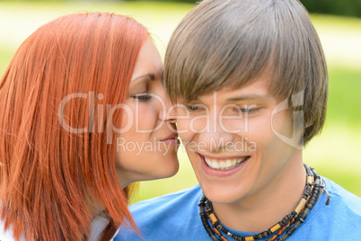 Loving young woman kissing boyfriend's cheek