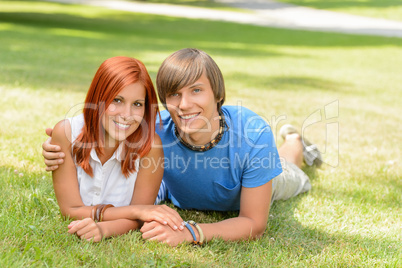 Teenage couple lying on grass summer love
