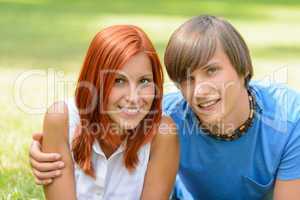 Teenage couple enjoy summer day smiling