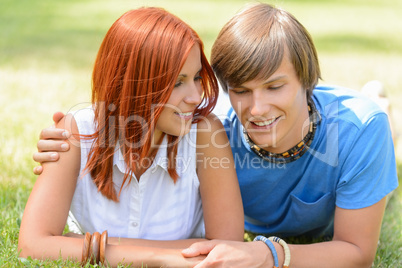 Teenage boyfriend and girlfriend lying on grass