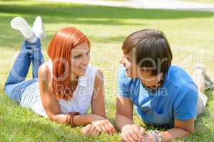 Couple lying on grass looking each other