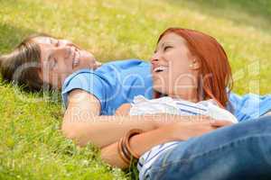Cheerful teenage couple laughing at each other