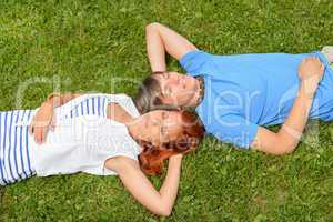 Teenage couple lying on grass