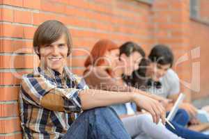 Student boy friends sitting in background