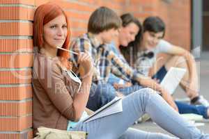 Young studying woman friends sitting in background