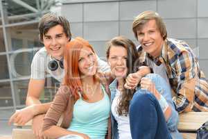 Cheerful student friends together outside campus