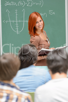 Student girl standing front of chalkboard math
