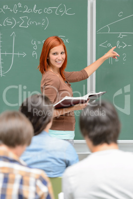 Mathematics student girl pointing on chalkboard