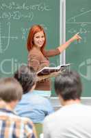 Mathematics student girl pointing on chalkboard