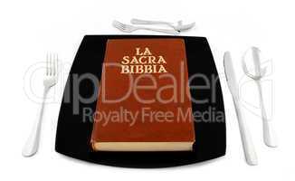 Metaphoric concept with bible in the plate with cutlery