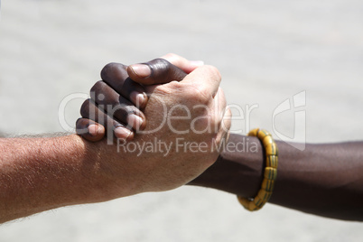 Handshake between a Caucasian and an African