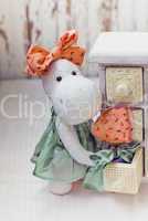 White hippo toy with textile and sewing accessory