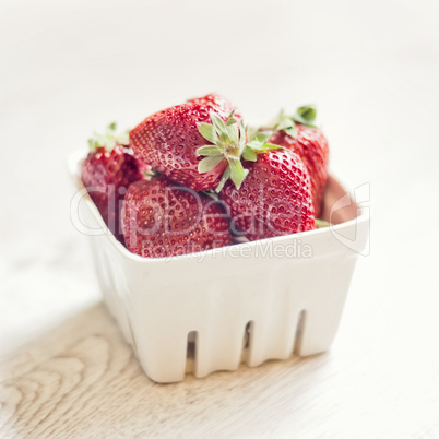 Fresh ripe strawberries on a vintage wooden background