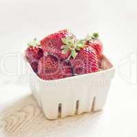Fresh ripe strawberries on a vintage wooden background