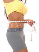 Teenager girl measuring tummy.