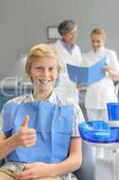Teenager visit dentist at dental surgery thumbup