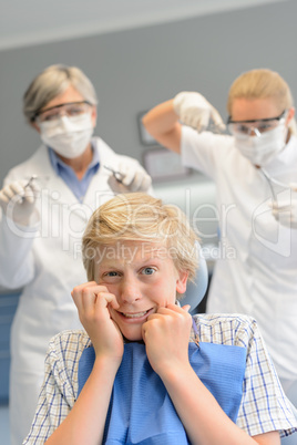 Scared teenage boy at dental surgery dentist