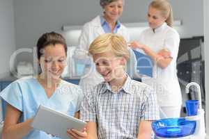 Teenage patient with professional dentist point tablet