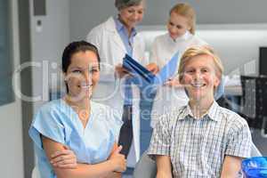 Dental team at stomatology clinic with teenager