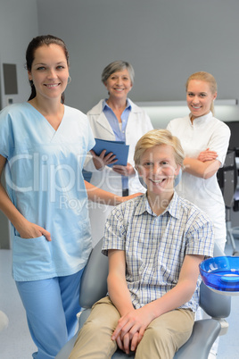 Team of dentists with teenager patient boy