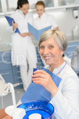 Elderly woman dentist team at dental surgery