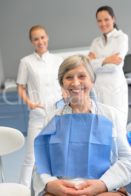 Senior woman patient with professional dentist team