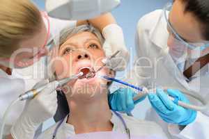 Senior woman patient dental check dentist team