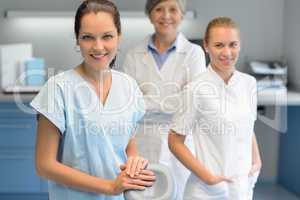 Three dentist woman team at dental surgery