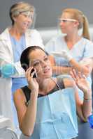 Busy woman patient calling at dentist office